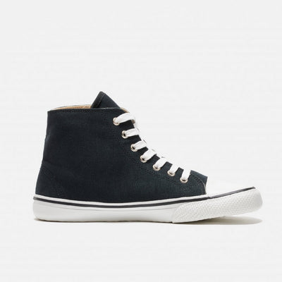 A photo of Bohempia Orik canvas high tops made from canvas and rubber soles. The sneakers are a black color with a white toe cap and a black outline around the rubber. The left sneaker is shown from the right side against a white background. #color_black-white