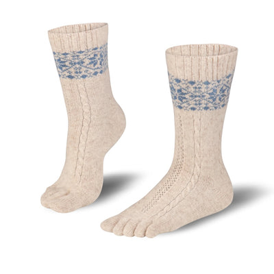 A photo of beige and blue knitted toe socks, they have blue detailed snowflake design around the mid-calf. Both socks are shown from the left side with one sock shown standing with the front of foot on the ground and the back heel lifted. They are shown on a white background. #color_beige-blue
