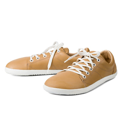Beige colored vegan sneakers shown from a side view on a white background. #color_beige