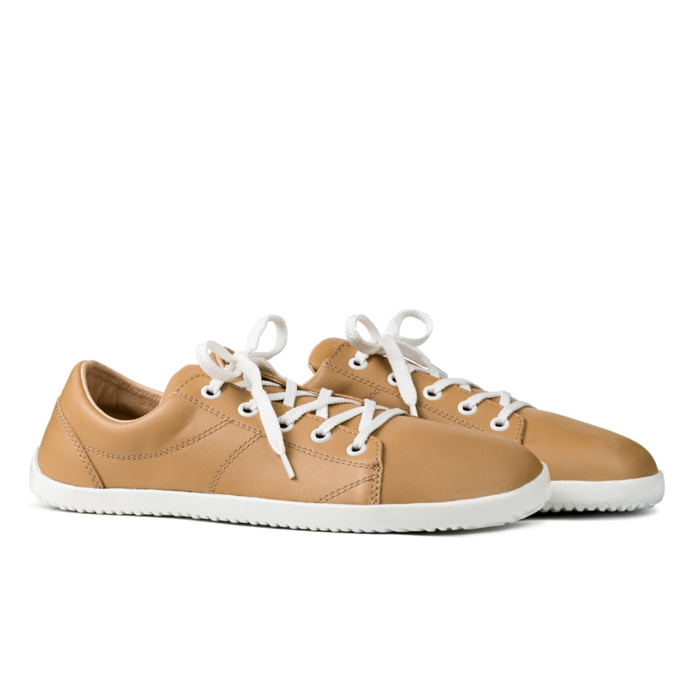 Beige colored vegan sneakers both shoes shown from a side view on a white background. #color_beige