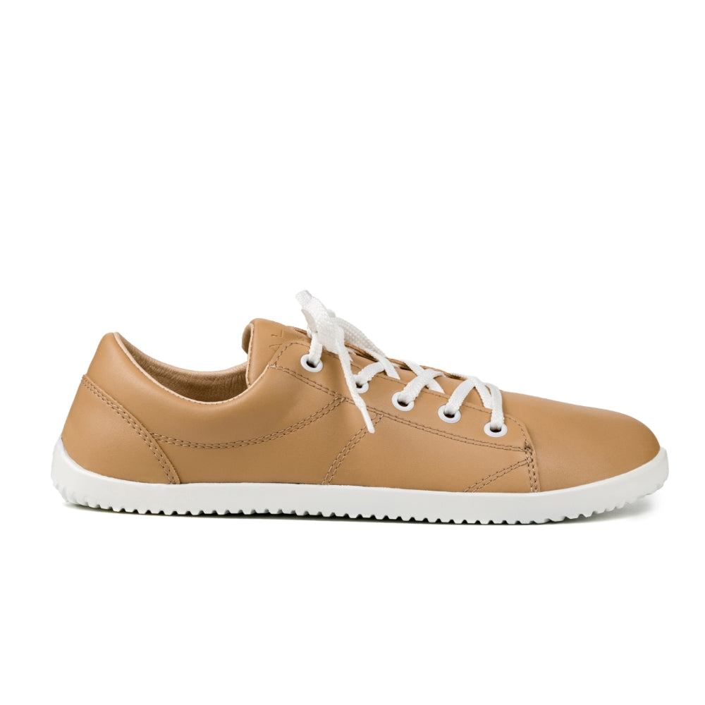 Beige colored vegan sneaker shown from a side view on a white background. #color_beige