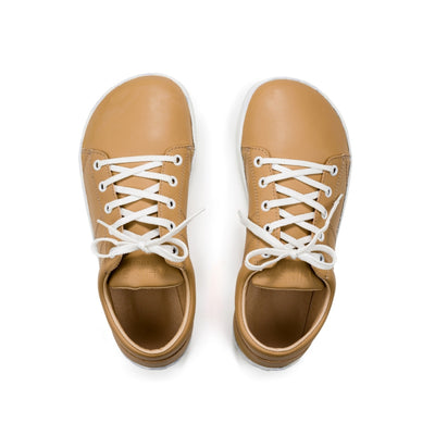 Beige colored vegan sneakers shown from a top down view of both shoes on a white background. #color_beige