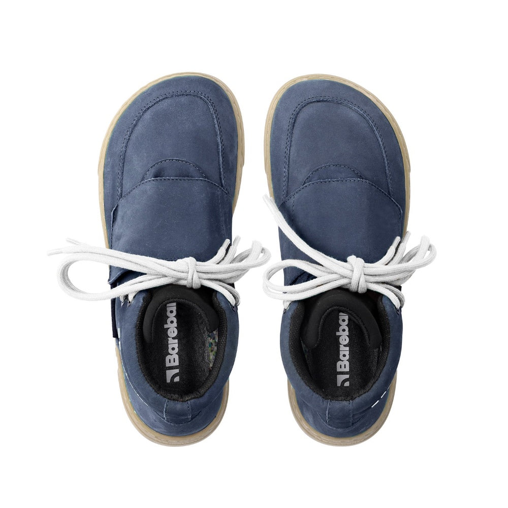 Photo 1 - A photo Barebarics Blizzard in navy blue with tan soles. Shoes are a high top/ankle boot style with a neoprine tongue, velcro colsure over that, and an easy lacing system that ties just at the ankle. Right shoe is shown from the right side against a white background. Photo 2 - Both shoes are shown from the top down against a white background. #color_navy-blue