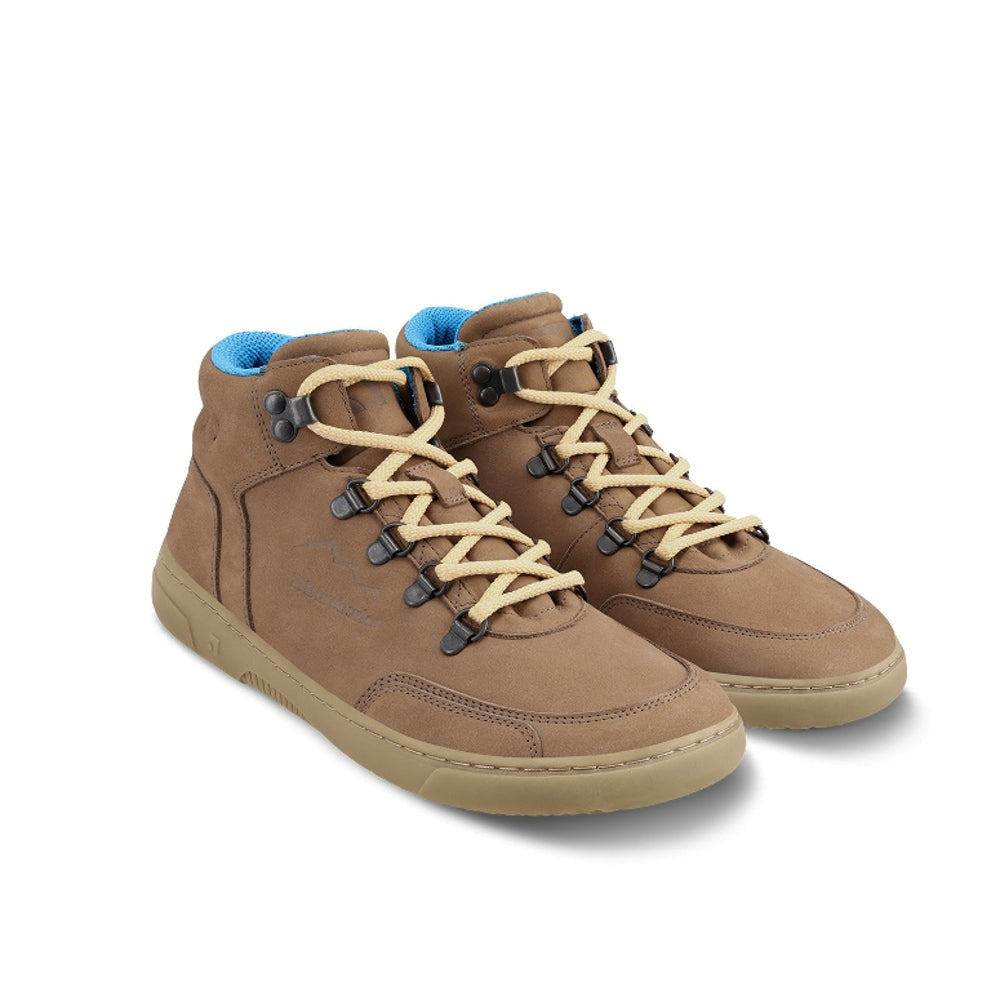 Photo 1 - A photo Barebarics Element chunky leather ankle boot sneakers in walnut brown with tan rubber soles. Tan laces are attached by boot eyelets. Right shoe is shown from the right side against a white background. Photo 2 - Both shoes are shown diagonally from the front right side against a white background. #color_walnut-brown