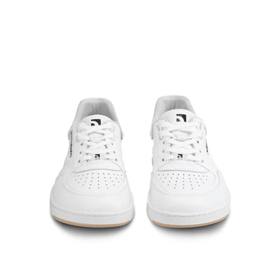 A photo of all white Barebarics Wave classic leath sneakers. Toe box is perforated, the sole is white with tan thread, barebarics brand name is written on the side. Both sneakers are shown here from the front against a white background. #color_all-white