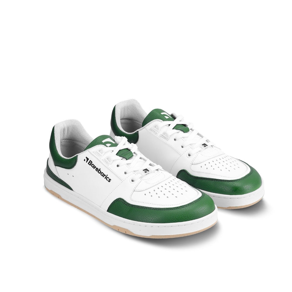 A photo of a green and white classic sneaker with a perforated toe box, the sole is white with tan thread, barebarics brand name is written on the side. Both sneakers are shown from the front angled slightly to the right against a white background. #color_white-dark-green