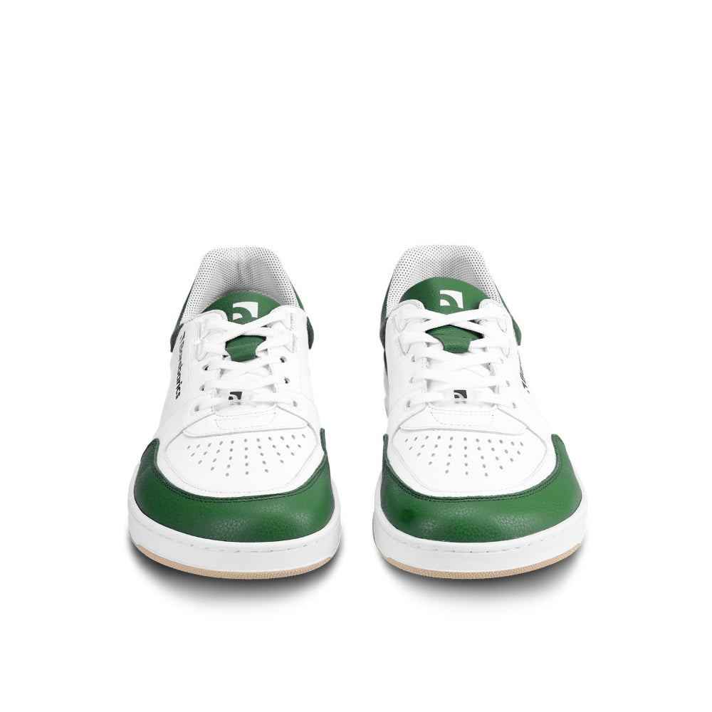 A photo of a green and white classic sneaker with a perforated toe box, the sole is white with tan thread, barebarics brand name is written on the side. Both sneakers are shown beside each other facing towards the front against a white background. #color_white-dark-green