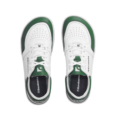 A photo of a green and white classic sneaker with a perforated toe box, the sole is white with tan thread, barebarics brand name is written on the side. Both sneakers are shown from the top down while facing upright against a white background. #color_white-dark-green