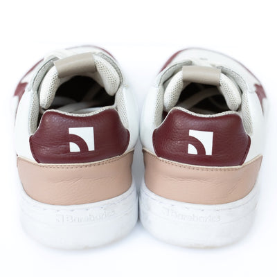 Barebarics Zing sneakers made with a leather upper and a rubber sole. The sneakers are white with burgundy accents around the front and side, and a tan accent over the heel. There are perforated spots on the top of the toe box and barebarics branding on the tongue and side. Both sneakers are shown side by side from behind, on a white background. #color_burgundy-anya-exclusive