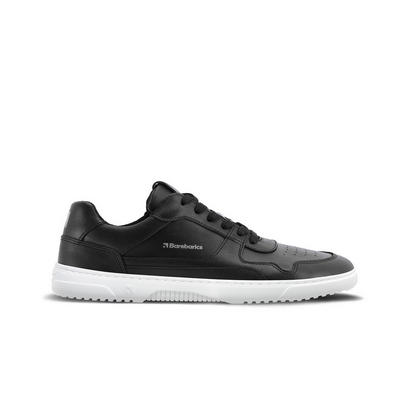 A photo of Barebarics Zing sneakers made with a black leather upper and a white rubber sole. The sneakers are a black color with perforated spots on the top of the toe box and barebarics branding on the tongue and side. The right sneaker is shown from the right side against a white background. #color_black-white