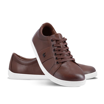 Photo 1 - A photo of white Be Lenka Elite leather sneakers. Shoes have perforated blocks on both sides of the shoe with a Be Lenka logo in the center. Sneakers are shown right stacked on left here against a white background. #color_dark-brown