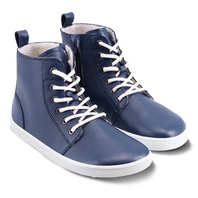 Photo 1 - A photo of Be Lenka Atlas ankle zip up boots made from smooth navy blue leather and white rubber soles. The boots have laces, zippers, a pull tab in the back, and are lined with felt. The right boot is shown from the right side against a white background. Photo 2 - Both shoes are shown from the top down against a white background. #color_navy-blue