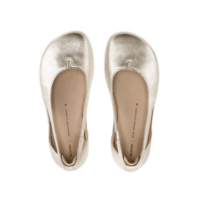 A photo of Be Lenka Bellissima flats with a leather upper and rubber soles. The flats are gold in color with a small stitching V detail in the front and a cut out design on the sides. Both shoes are shown from the top down against a white background in this photo. #color_gold