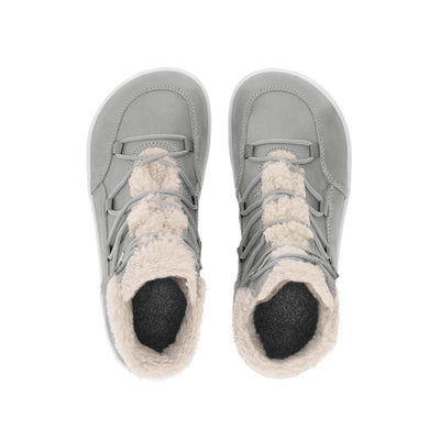 A photo of Belenka Bliss Boots made from nubuck leather and light grey rubber soles. The boots are grey and have fleece surrounding the whole tongue and around the ankle. The laces are wide across the boot top and have speed hooks at the by the top. Both boots are shown from the top down against a white background. #color_cloud-grey