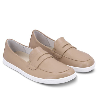A photo of a penny loafer with a decorative vamp. Both loafers are shown beside each other angled to the right. The loafers are latte in color with a white sole shown against a white background. #color_latte-brown