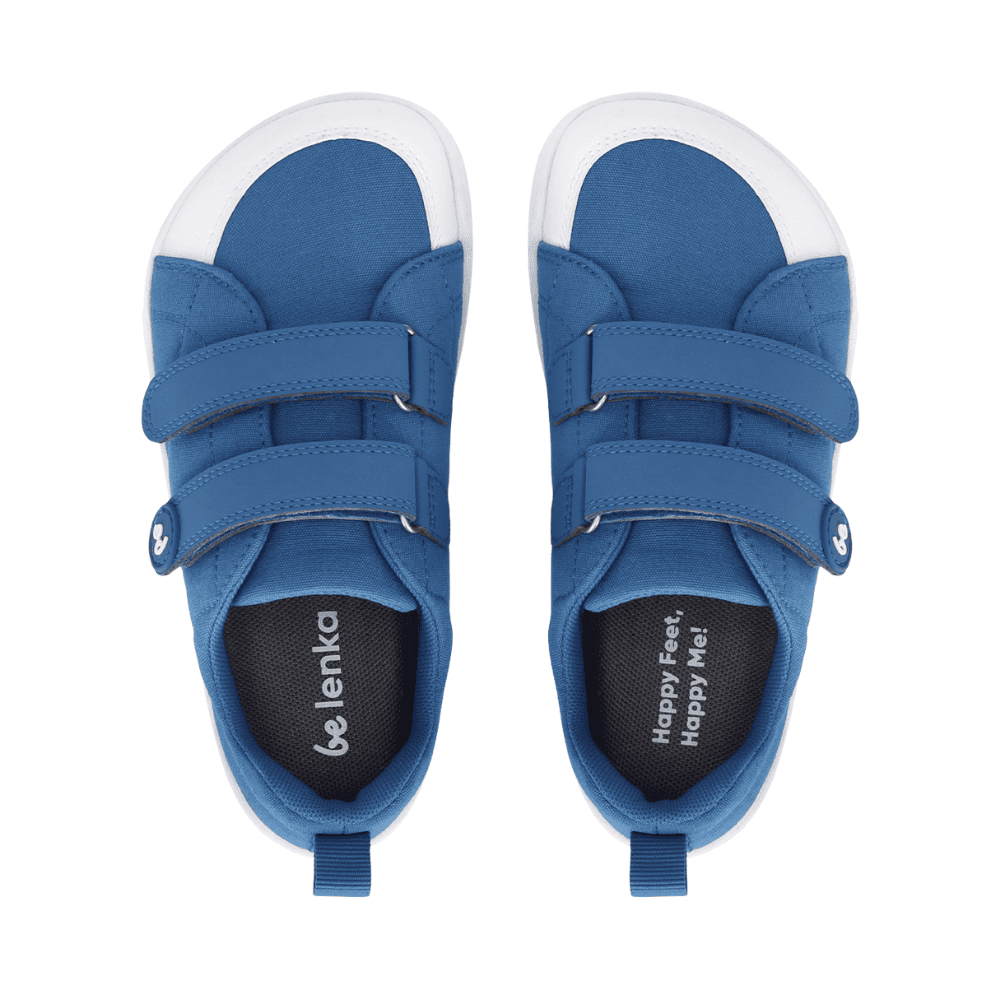 Blue canvas Be Lenka Canvi sneakers with  two velcro straps, white faux suede toe caps, white and teal rubber soles, and a pull tab at the heel. Both shoes are shown from above against a white background. #color_blue