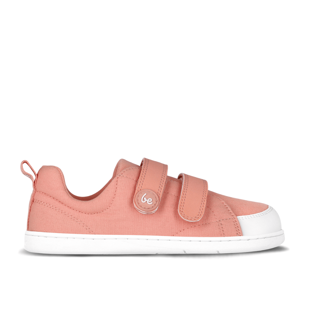 Light coral pink canvas Be Lenka Canvi sneakers with two velcro straps, white faux suede toe caps, white and coral pink rubber soles, and a pull tab at the heel. Right shoe is shown facing right against a white background. #color_coral-pink