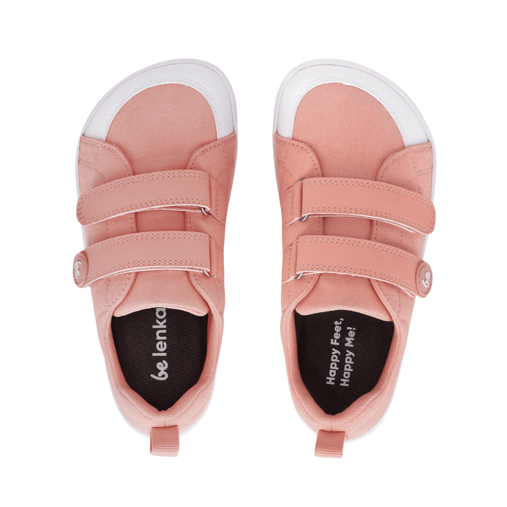 Light coral pink canvas Be Lenka Canvi sneakers with two velcro straps, white faux suede toe caps, white and coral pink rubber soles, and a pull tab at the heel. Both shoes are shown from above against a white background. #color_coral-pink