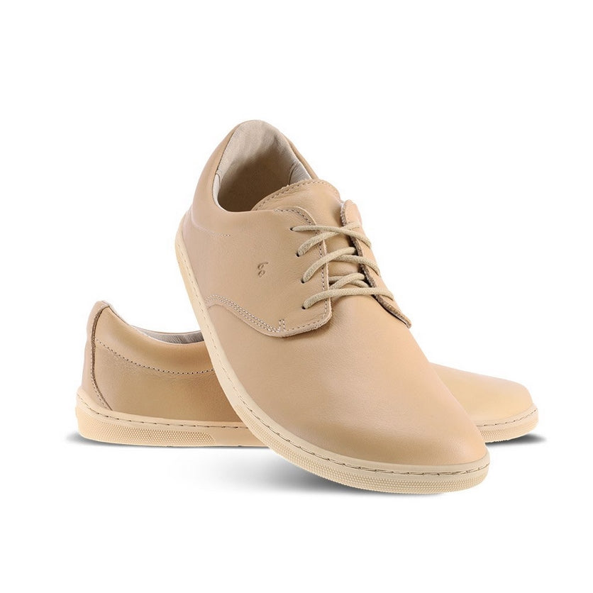 A photo of Salted Caramel Brown Be Lenka Cityscape Simple Leather Lace Up shoes with beige soles. Left shoe is shown from the right with the right shoe propped up on the left to show the top of the shoe. Background is white. #color_salted-caramel-brown