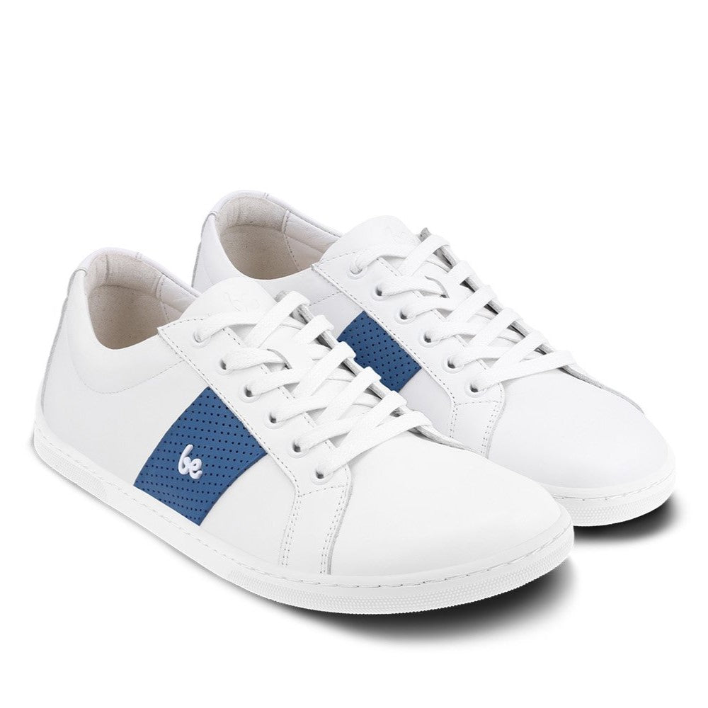 White leather Be Lenka Elite shoes with a thick, perforated, diagonal, blue leather stripe on both sides of the sneaker. A cursive, metal "be"  logo design is in the center of the outside stripe. Both shoes are facing diagonally right against a white background. #color_white-dark-blue