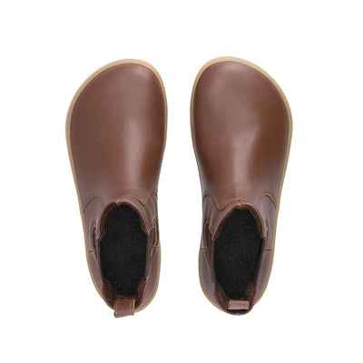 A photo of Belenka Entice Neo boots made from smooth leather and tan rubber soles. The boots are brown in color with dark brown elastic panels on the sides and pull on loops. Both shoes are shown from above against a white background. #color_dark-brown