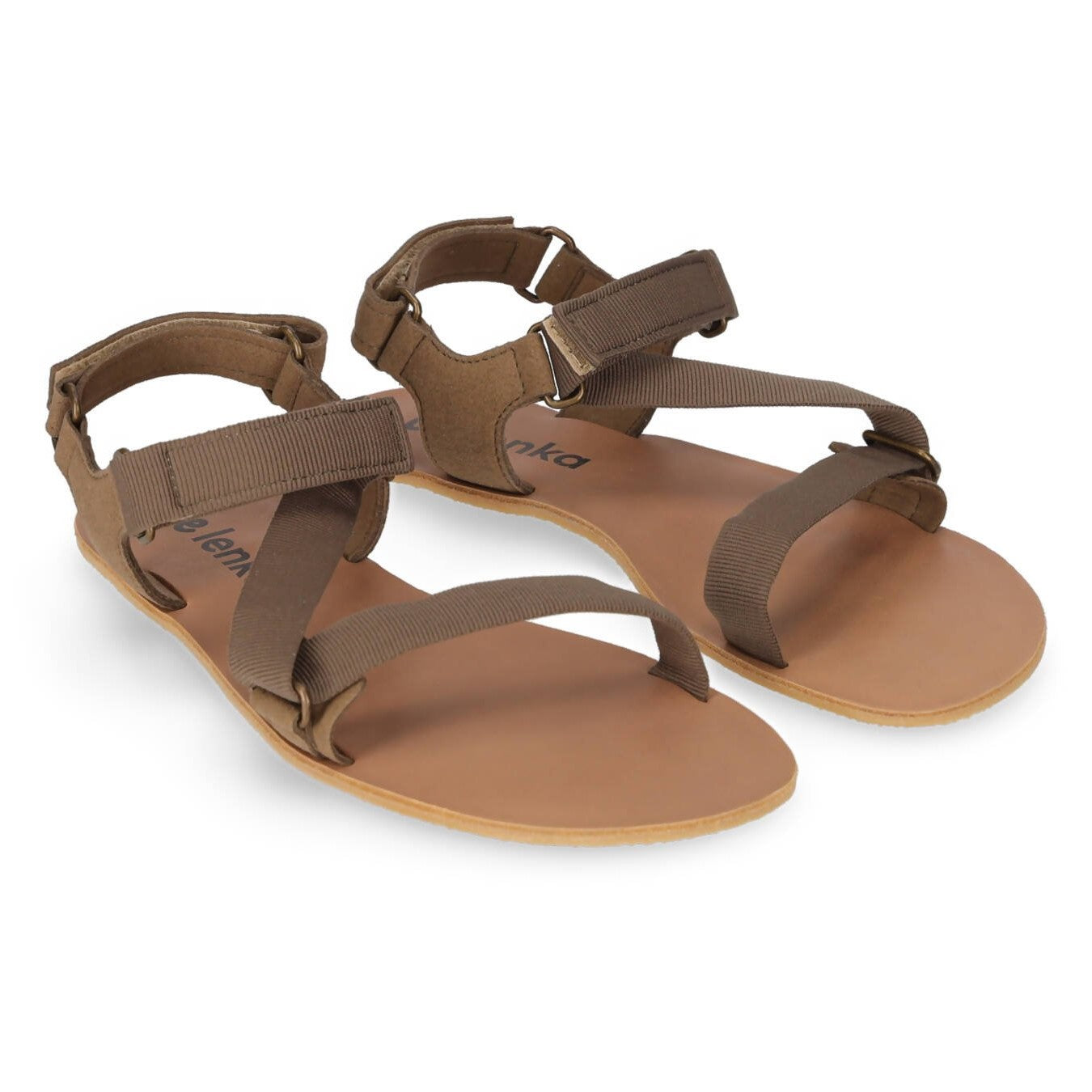 A photo of Olive Green Be Lenka Flexi Sandals made with fabric straps with velcro and a tan leather topped rubber soles. The sandals have straps that cross the front of the foot and continue around the mid-foot, ankle, and heel. Both sandals are shown facing diagonally right against a white background. #color_olive-green