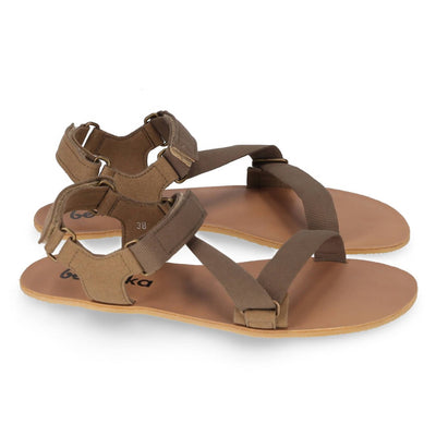 A photo of Olive Green Be Lenka Flexi Sandals made with fabric straps with velcro and a tan leather topped rubber soles. The sandals have straps that cross the front of the foot and continue around the mid-foot, ankle, and heel. Both sandals are shown facing right against a white background. #color_olive-green