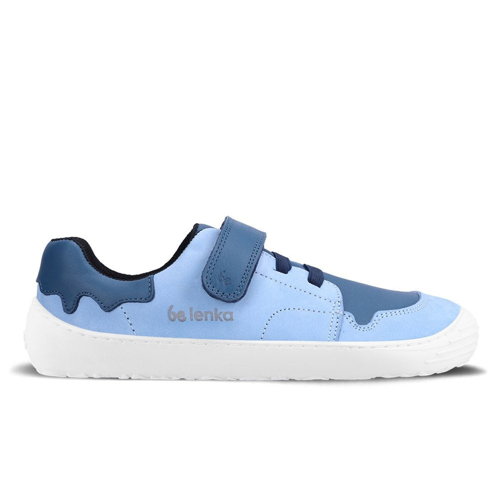 A photo of blue Be Lenka Gelato kids leather sneakers with white rubber soles. Shoes are light blue with dark blue accent color blocks on the tongue, toe box, single top velcro closure, two elastic laces below that, and a "dripping" ice cream color block on the heel. Right shoe is facing right against a white background. #color_blue