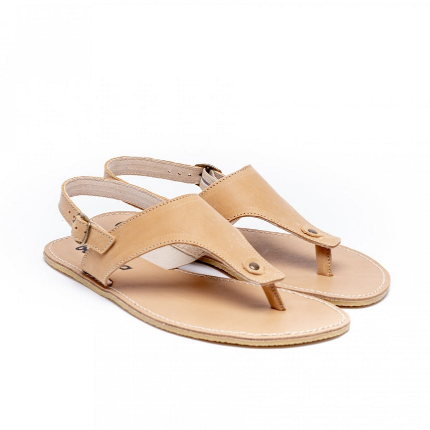 A photo of Sand Be Lenka Promenade Sandals made with leather and tan rubber soles. The sandals have tan thong straps and a heel strap with a buckle. Both sandals are shown diagonally from the right side against a white background in this photo. #color_sand