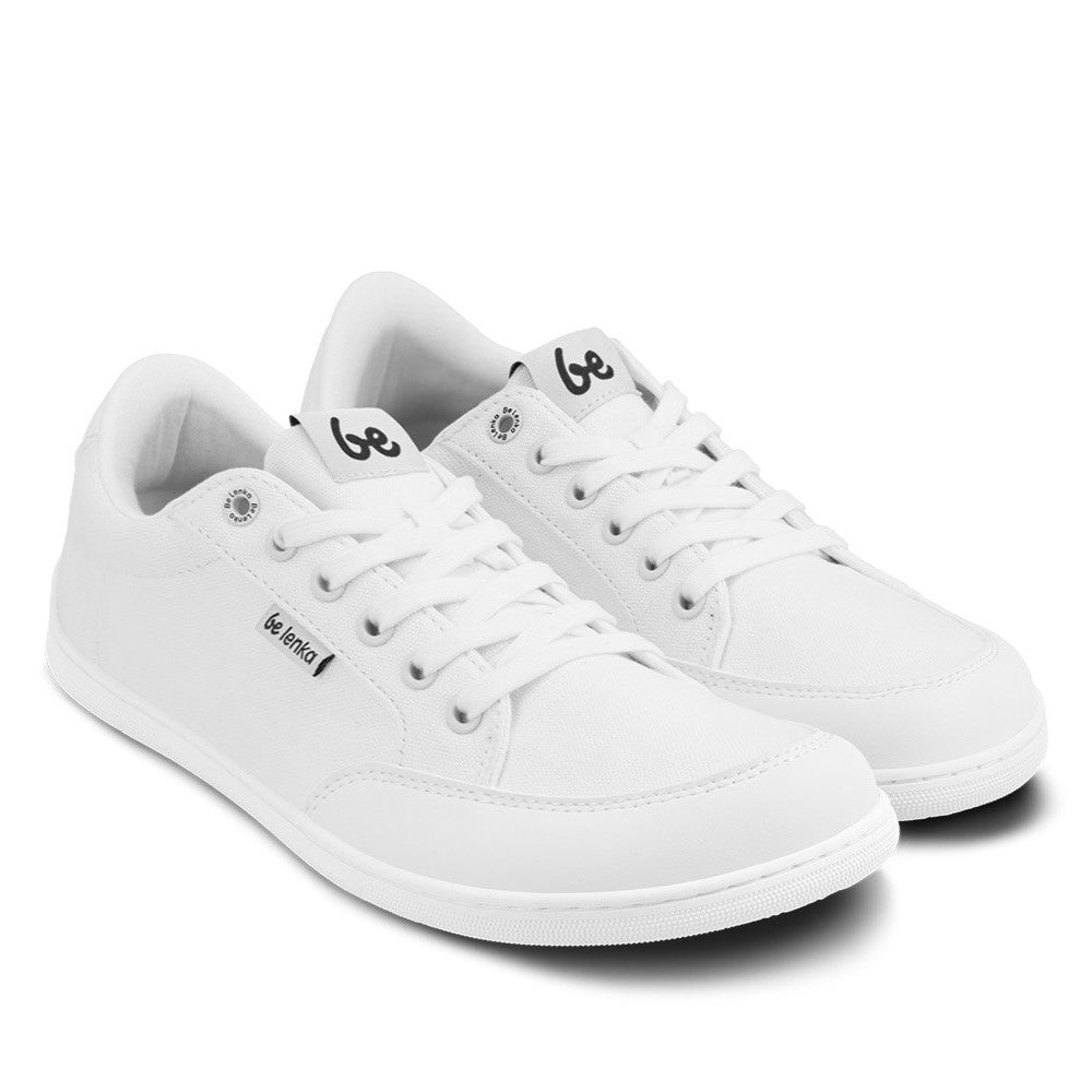 All White Be Lenka Rebound sneakers with white laces, microfiber toe guards, heel accents, and rubber soles. Both shoes are shown facing diagonally right against a white background. #color_all-white