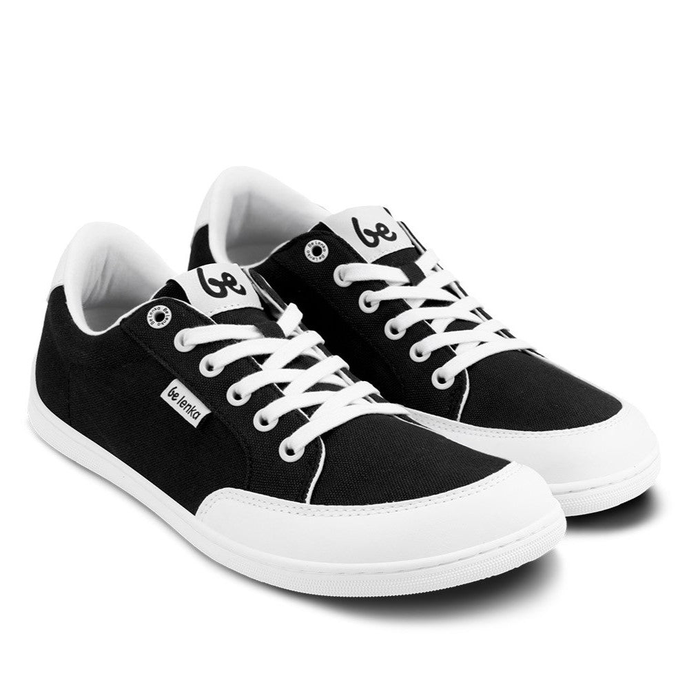 Black Be Lenka Rebound sneakers with white laces, microfiber toe guards, heel accents, and rubber soles. Both shoes are facing diagonally right against a white background. #color_black-white
