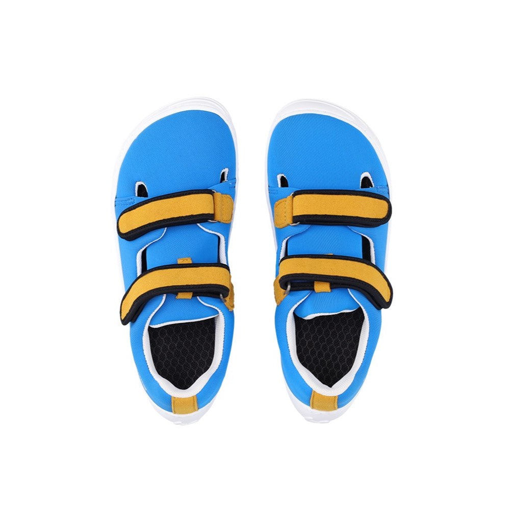 Photo 1 - A photo Be Lenka Kids Seasiders summer sandal sneakers in blue with white soles. Shoes are made of neoprene with two velcro straps. Straps are yellow with white edging, resembling a royal blue tang fish. The tongue does not quite touch the side of the shoe, leaving some breathable holes for summer time. Right shoe is shown from the right side against a white background. Photo 2 - Both shoes are shown from the top down against a white background. #color_bluelicious