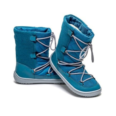 Photo 1 - A photo of Be Lenka Kids Snowfox boots in dark teal. Blue suede and textile and light grey soles surround the outside. Grey laces are widely connected from side to side starting at the ball of the foot and going until the top of the boot. Right boot is shown from the right side against a white background. Photo 2 - Both shoes are shown here with the left shoe facing right and the right shoe heel propped up on the left shoe against a white background. #color_dark-teal