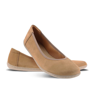A photo of the Be Lenka Sophie flats made from a leather upper and a microfiber interior. The flats are toffee brown in color with tan rubber soles and are a simple ballerina flat design. The right shoe is shown with its heel propped on the left shoe on a white background. #color_toffee-brown