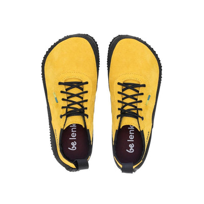 A photo of a hiking sneaker with a long heel pull on tab. Both sneakers are shown front the top down facing towards the top of the screen. The sneakers are mustard in color with black above the sole and bump rubber thread against a white background. #color_mustard