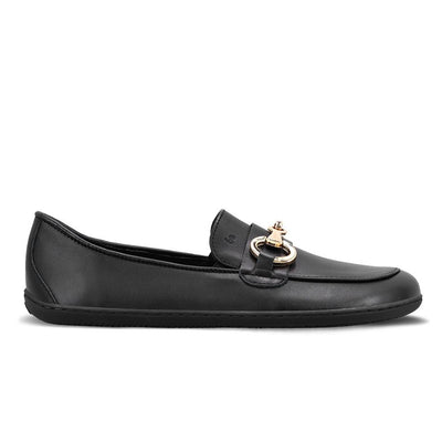 A photo of Black Be Lenka Viva leather loafers. A gold buckle detail graces the vamp. TR soles are stitched on for longevity. Right shoe is shown here facing right against a white background. #color_black