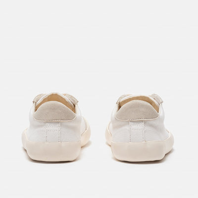 A photo of the Bohempia Felix vegan sneakers made from hemp canvas. The sneakers are white in color with a vegan suede tan toe cap and heel detail, with a tan sole and laces. Both shoes are shown together from behind on a white background. #color_white-tan
