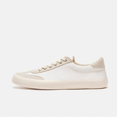 A photo of the Bohempia Felix vegan sneakers made from hemp canvas. The sneakers are white in color with a vegan suede tan toe cap and heel detail, with a tan sole and laces. The left shoe is shown from the left side on a white background. #color_white-tan