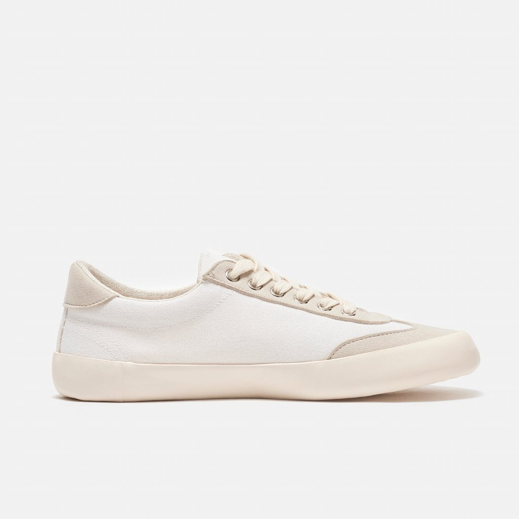 A photo of the Bohempia Felix vegan sneakers made from hemp canvas. The sneakers are white in color with a vegan suede tan toe cap and heel detail, with a tan sole and laces. The left shoe is shown from the right side on a white background. #color_white-tan