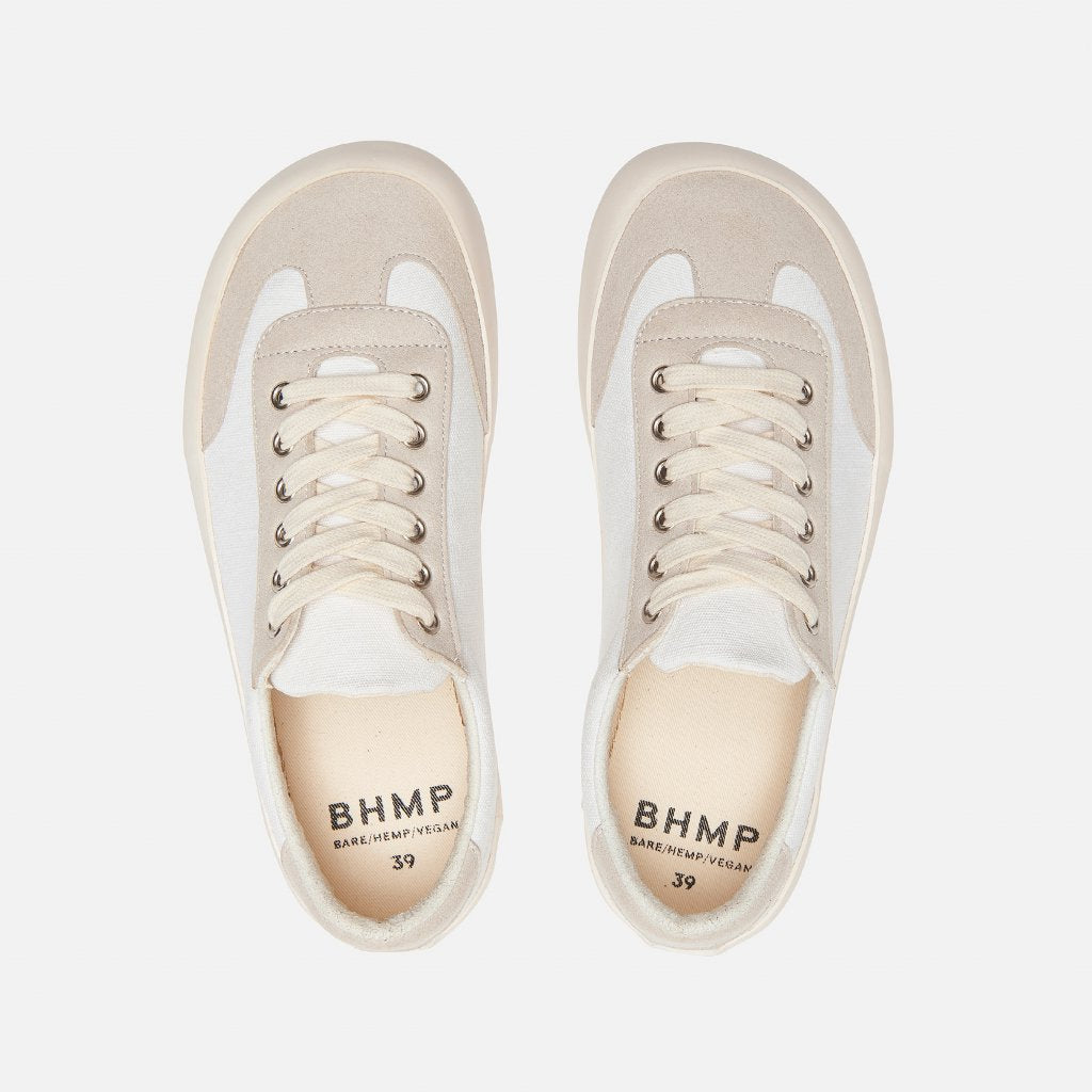 A photo of the Bohempia Felix vegan sneakers made from hemp canvas. The sneakers are white in color with a vegan suede tan toe cap and heel detail, with a tan sole and laces. Both shoes are shown together from above on a white background. #color_white-tan