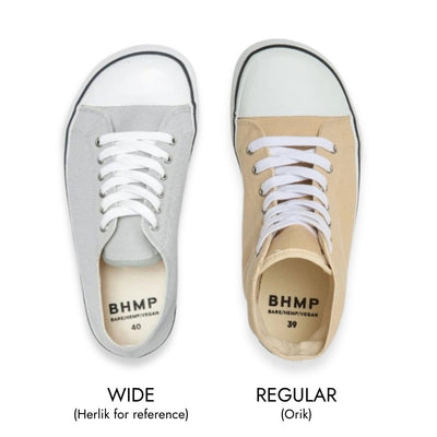 Tan Bohempia Orik canvas high tops. Sneakers have a white rubber toe cap with a black outline around the upper white rubber soles. Right shoe in regular width is shown from above next to the Bohempia Herlik light grey in wide for reference against a white background. #color_tan-white