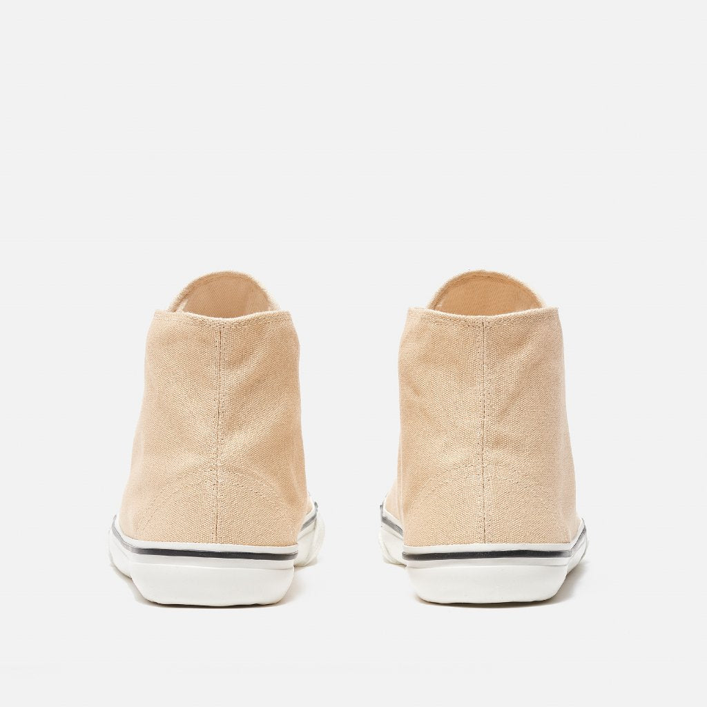 A photo of Bohempia Orik canvas high tops made from canvas and rubber soles. The sneakers are a tan color with a white toe cap and a black outline around the white rubber soles. Both sneakers are shown from the back against a white background. #color_tan-white