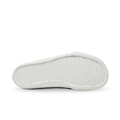 Tan Bohempia Orik canvas high tops. Sneakers have a white rubber toe cap with a black outline around the upper white rubber soles. Right shoe sole is shown facing right against a white background. #color_tan-white