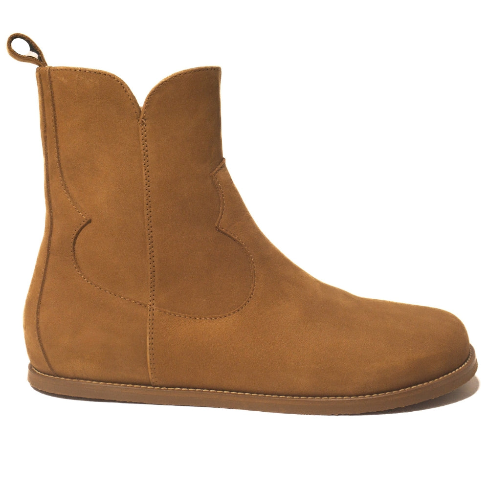 Light brown, nubuck leather western Faye boots By Anya with a western shape on both sides of the ankles, a zipper, tan rubber soles, a welt stitching design around the top of the sole, and a pull tab at the top back of the opening. Right boot is shown facing right against a white background. #color_cider