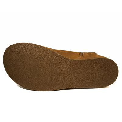 Light brown, nubuck leather western Faye boots By Anya with a western shape on both sides of the ankles, a zipper, tan rubber soles, a welt stitching design around the top of the sole, and a pull tab at the top back of the opening. Right boot sole is shown facing left against a white background. #color_cider