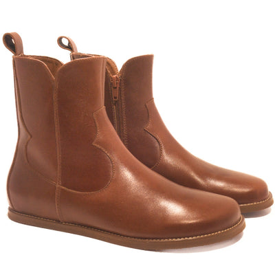 Smooth brown leather western Faye boots By Anya with a western shape on both sides of the ankles, a zipper, tan rubber soles, a welt stitching design around the top of the sole, and a pull tab at the top back of the opening. Both boots are shown facing diagonally right against a white background. #color_cognac