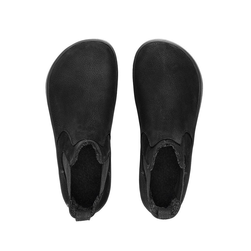 A photo of Be Lenka Entice boots made from nubuck leather and rubber soles. The boots are black in color, they are a Chelsea boot style with elastic at the sides. Both boots are shown from above against a white background. #color_matte-black