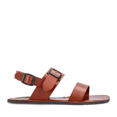 Cognac leather Groundies Kos Sandals with black rubber soles. One thick strap spans across the base of the toes while another goes across the arch of the foot with a big, black buckle closure. A thinner slingback strap keeps the sandals secure to the foot also with a buckle closure. Right shoe is shown facing right against a white background. #color_cognac