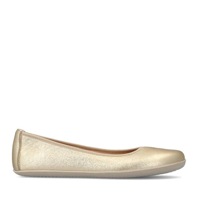 A photo of Groundies Lily Classic flats with a leather upper and white rubber true sense soles. The flats are a smooth leather in a metallic champagne color with trim around the tops. The interior of the flats is a light beige color. The left flat is shown from the right side against a white background. #color_metallic-champagne