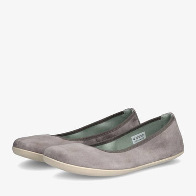 A photo of Groundies Lily Soft flats with a leather upper and cream rubber true sense soles. The flats are a nubuck in a grey color, the trim around the tops of the flats is also grey and is darker in color than the rest of the flats. Both flats are shown together from the front left side against a white background. #color_grey